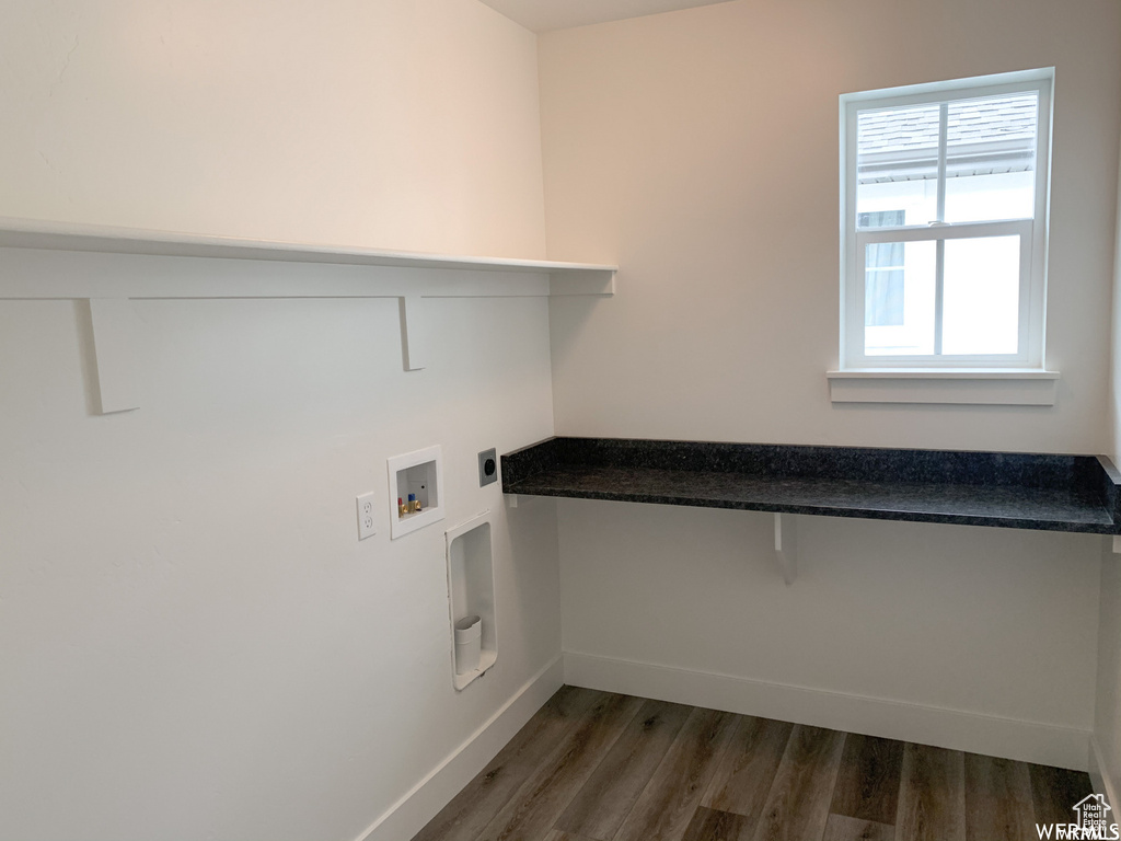 Washroom with hookup for a washing machine, electric dryer hookup, and dark hardwood / wood-style floors