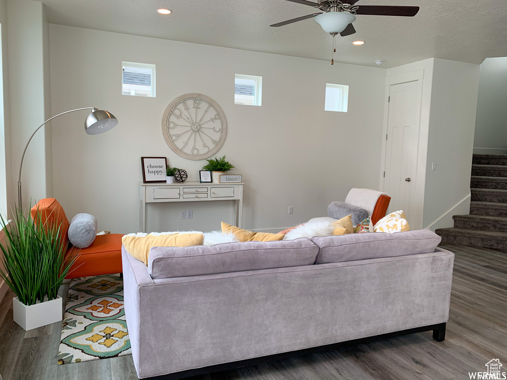 Living room featuring wood-type flooring and ceiling fan