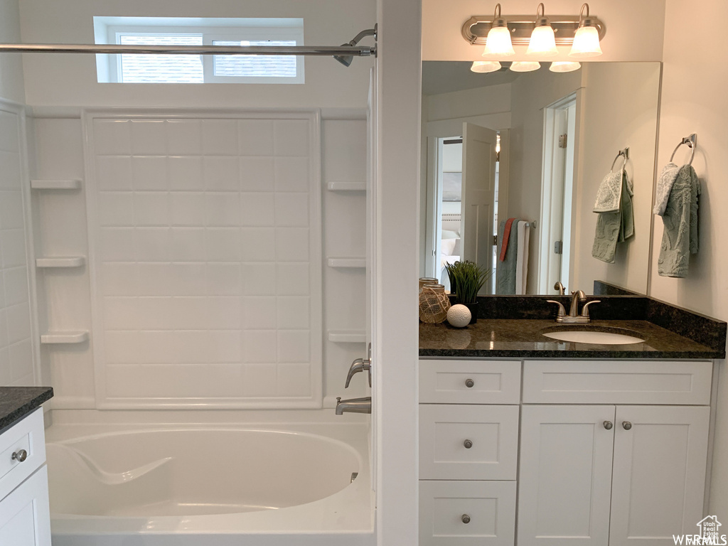 Bathroom featuring vanity and bathtub / shower combination