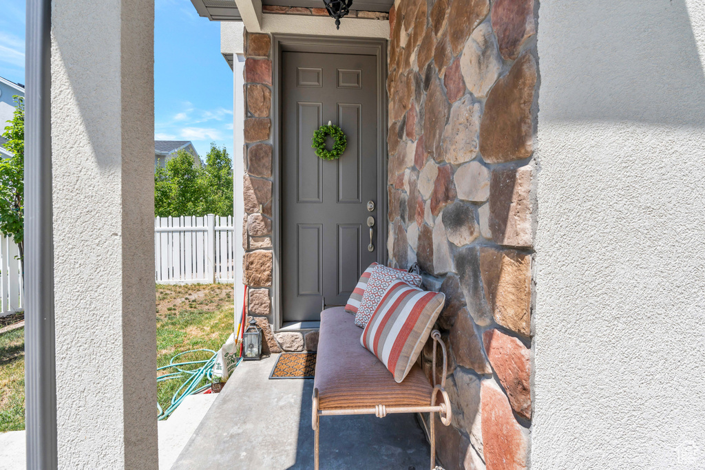 View of exterior entry with a patio area