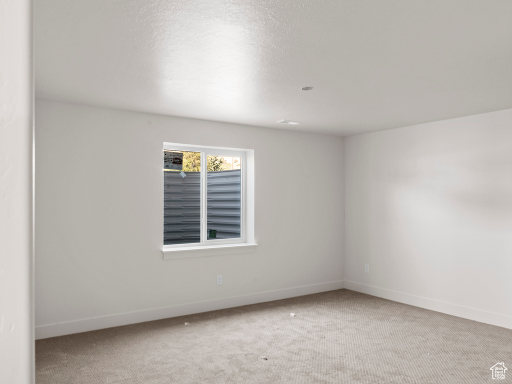 Unfurnished room with carpet