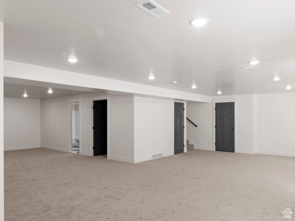 Basement with light colored carpet