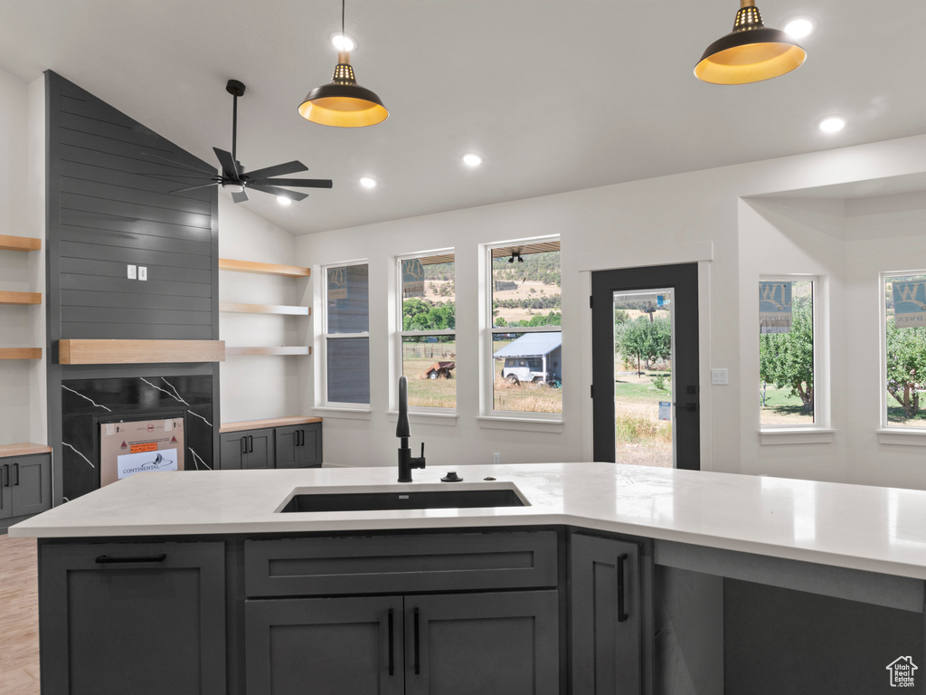 Kitchen with hardwood / wood-style flooring, sink, lofted ceiling, ceiling fan, and gray cabinets