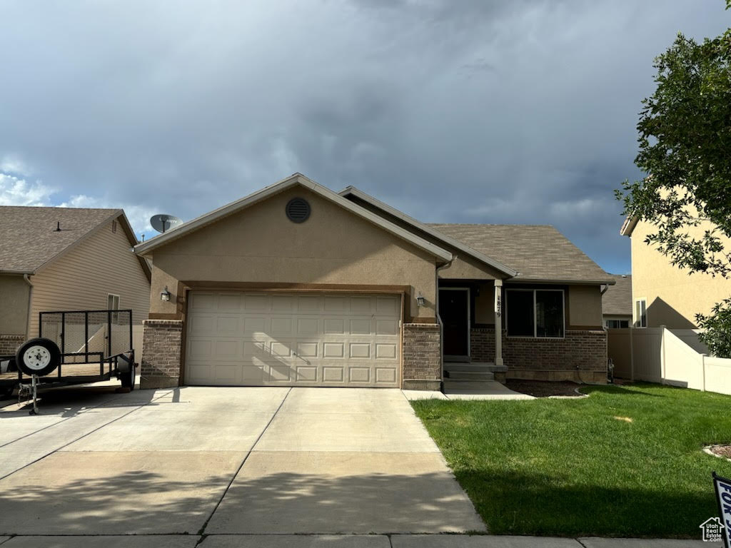 View of front facade with a front yard and a garage