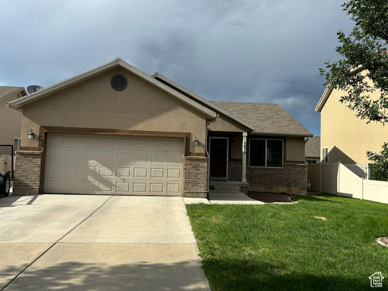 View of front facade with a garage and a front yard