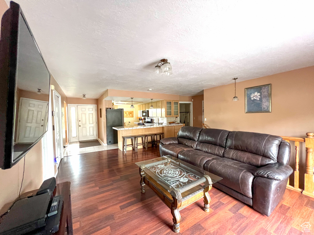 Living room with hardwood / wood-style flooring and a textured ceiling