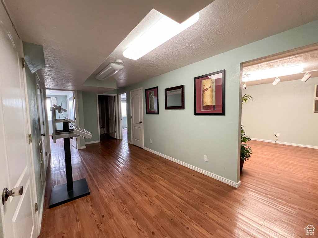 Interior space featuring a textured ceiling and hardwood / wood-style floors