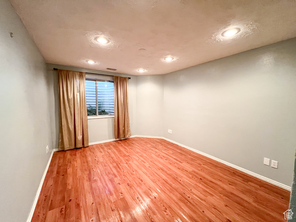 Unfurnished room featuring wood-type flooring