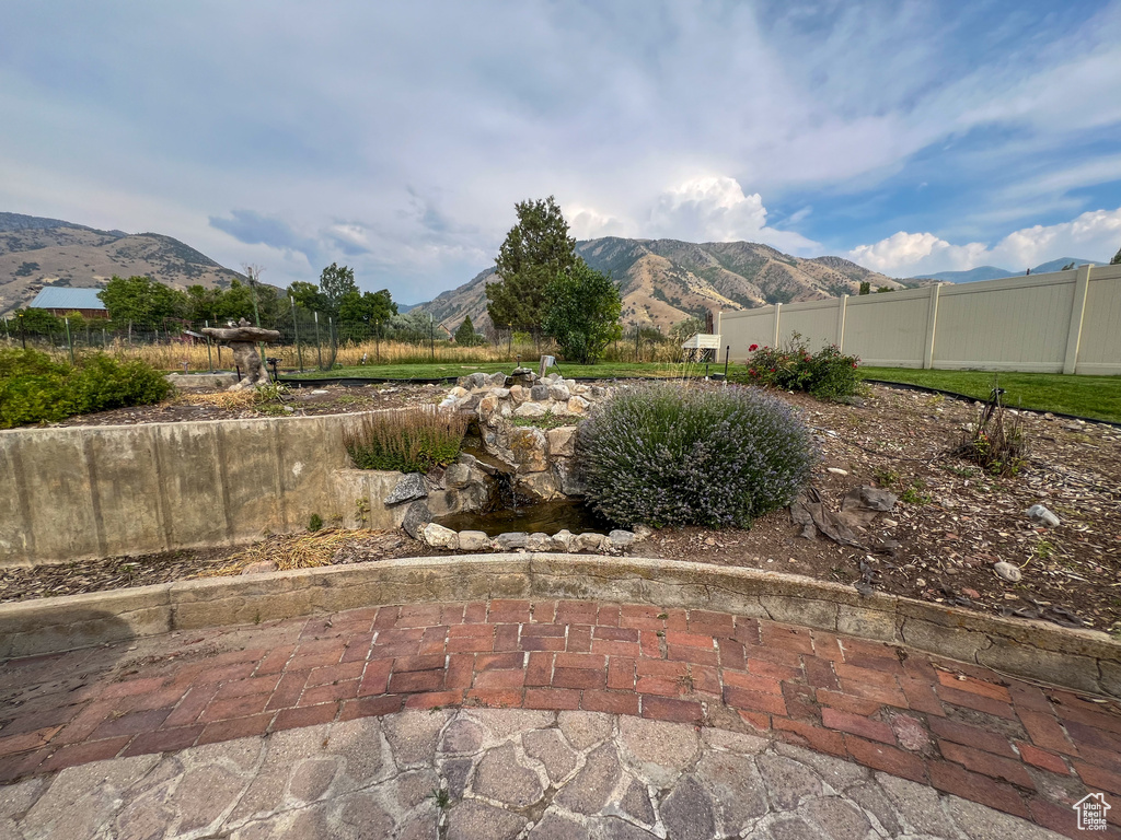 View of yard featuring a patio and a mountain view