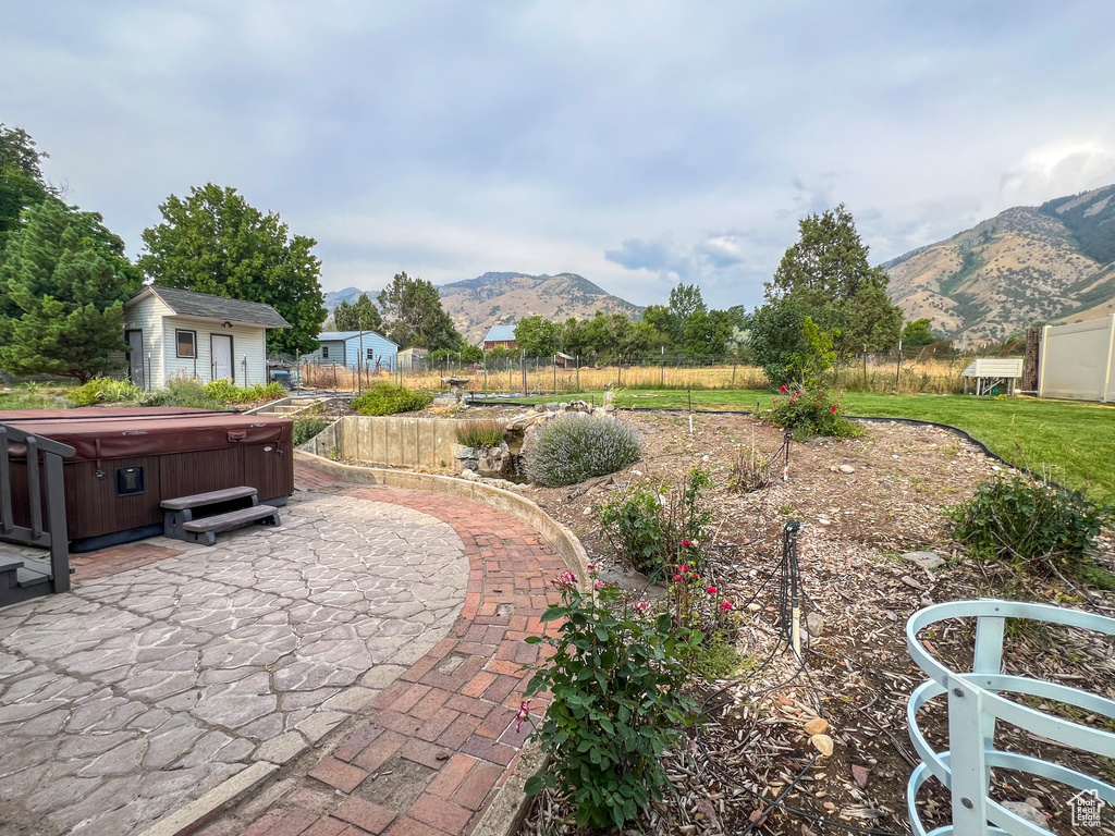 View of patio featuring a mountain view and a hot tub