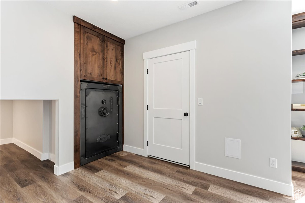 Laundry room with wood-type flooring