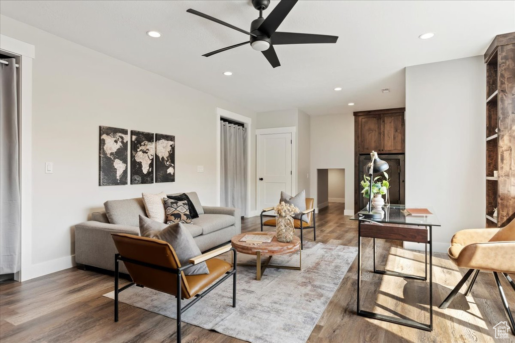 Living room featuring hardwood / wood-style flooring and ceiling fan