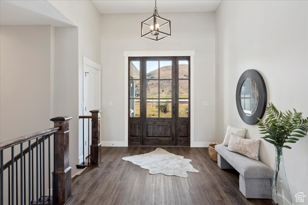 Entrance foyer featuring an inviting chandelier and dark hardwood / wood-style floors