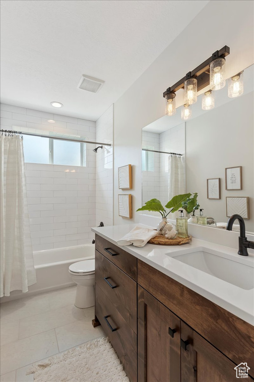 Full bathroom with shower / tub combo, tile patterned flooring, toilet, and vanity