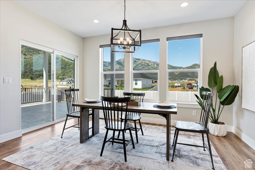 Dining space featuring light hardwood / wood-style flooring and a notable chandelier