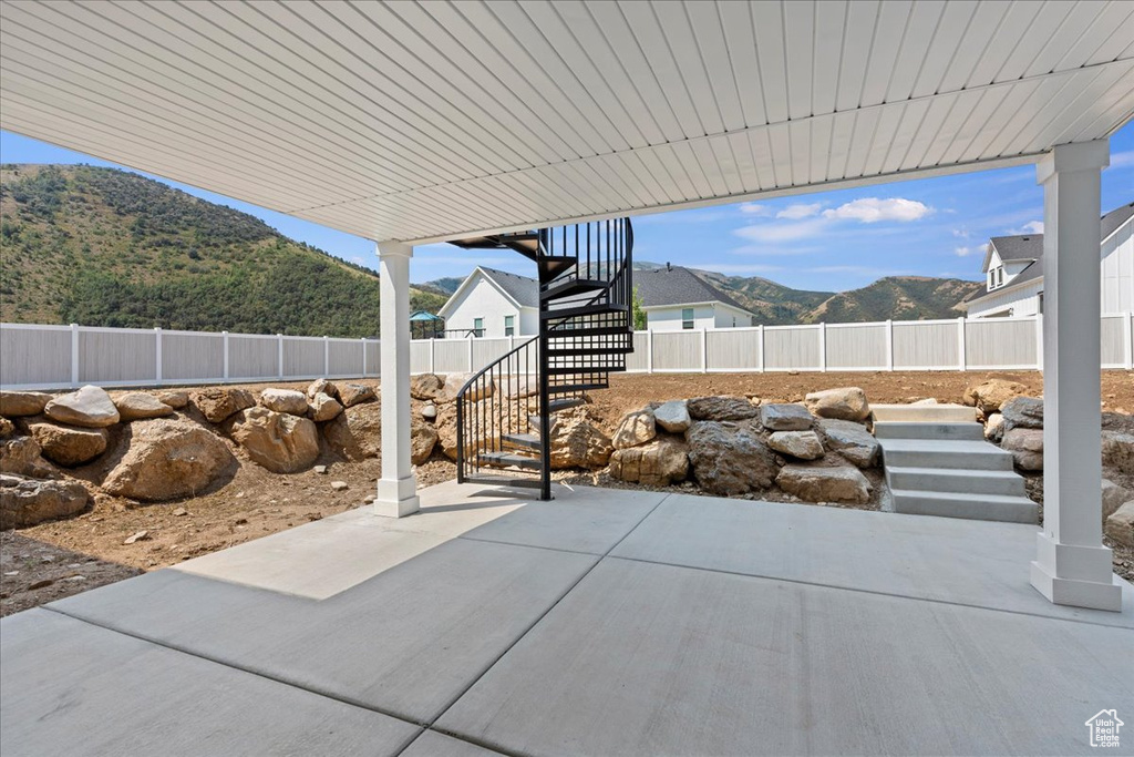 View of patio / terrace with a mountain view and a playground