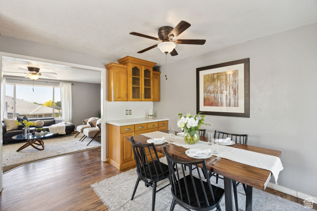 Dining space featuring ceiling fan and hardwood / wood-style floors