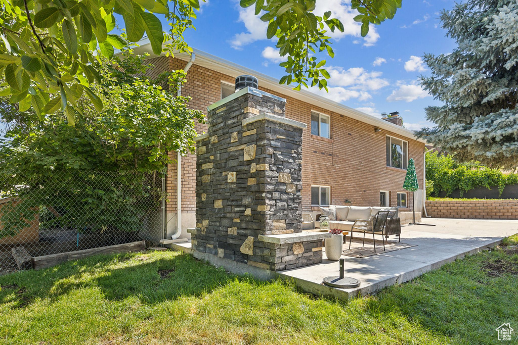 Back of house featuring a patio, an outdoor hangout area, and a lawn