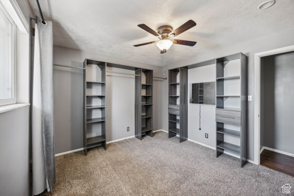 Interior space featuring carpet flooring and ceiling fan