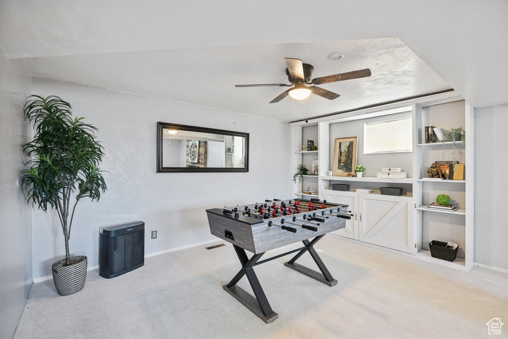 Rec room with light colored carpet and ceiling fan