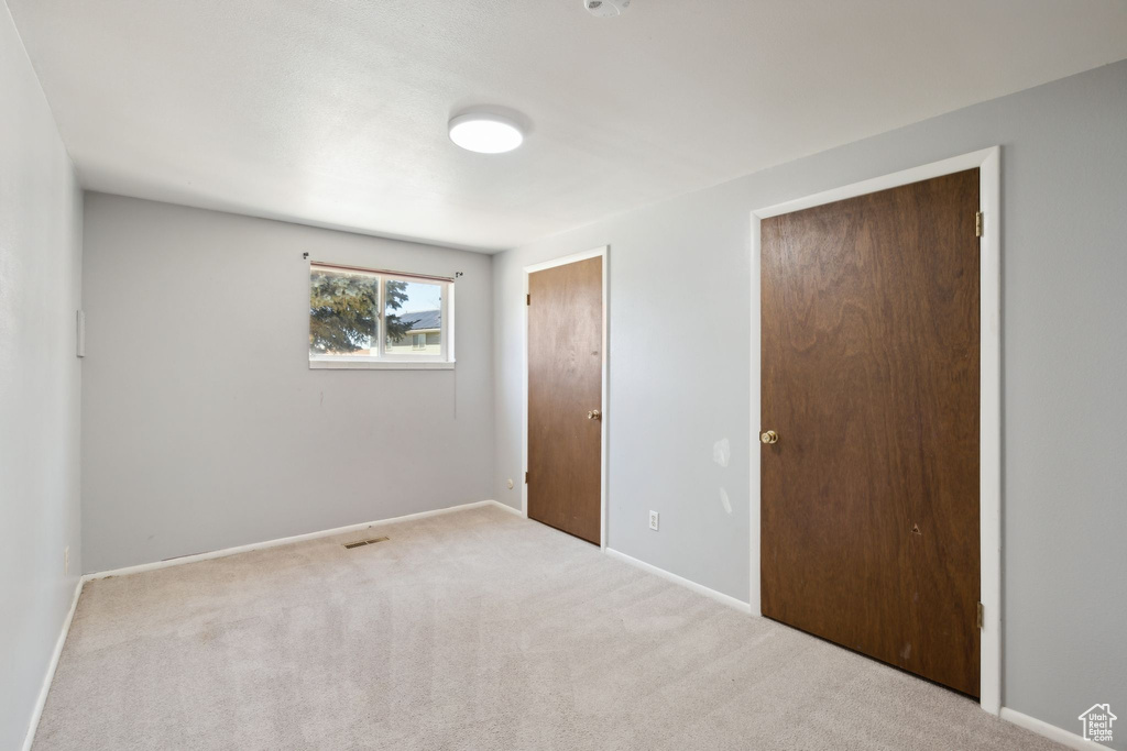 Unfurnished bedroom with carpet flooring