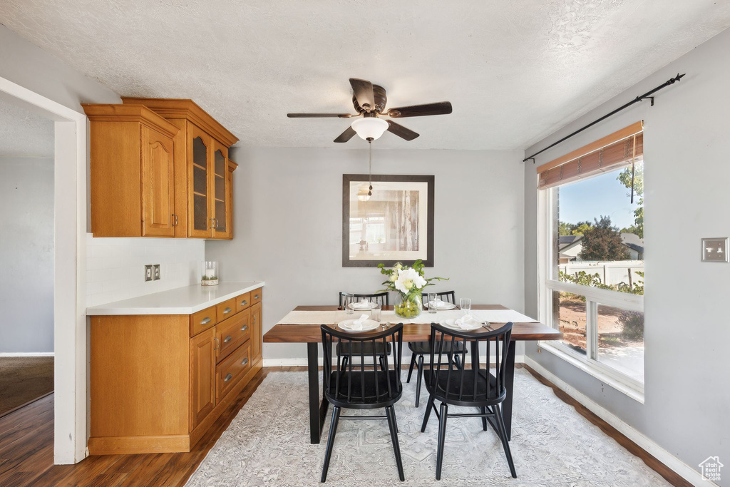 Dining area featuring a textured ceiling, ceiling fan, and hardwood / wood-style floors