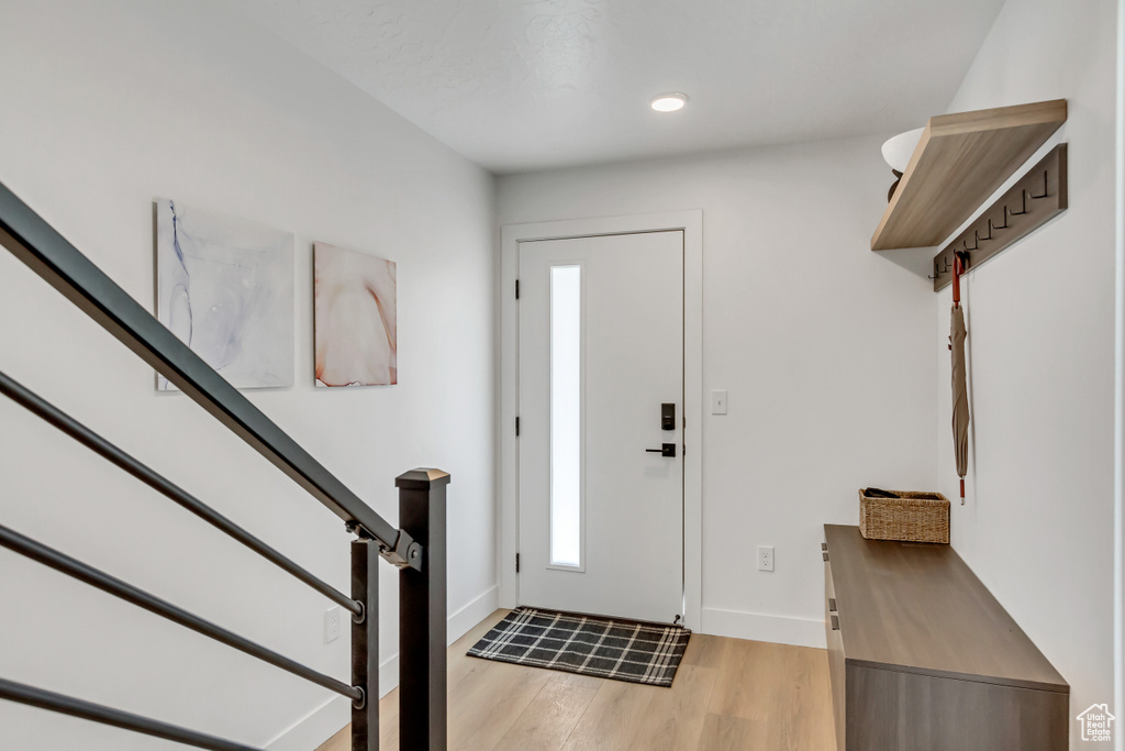 Entrance foyer with light hardwood / wood-style floors