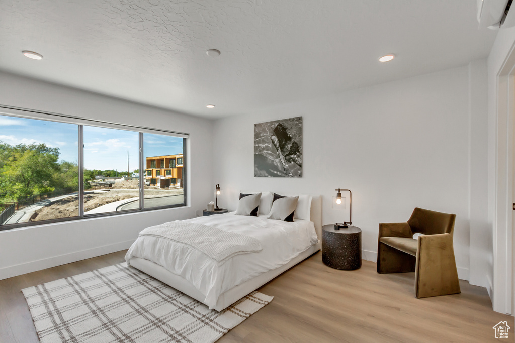 Bedroom with light hardwood / wood-style flooring