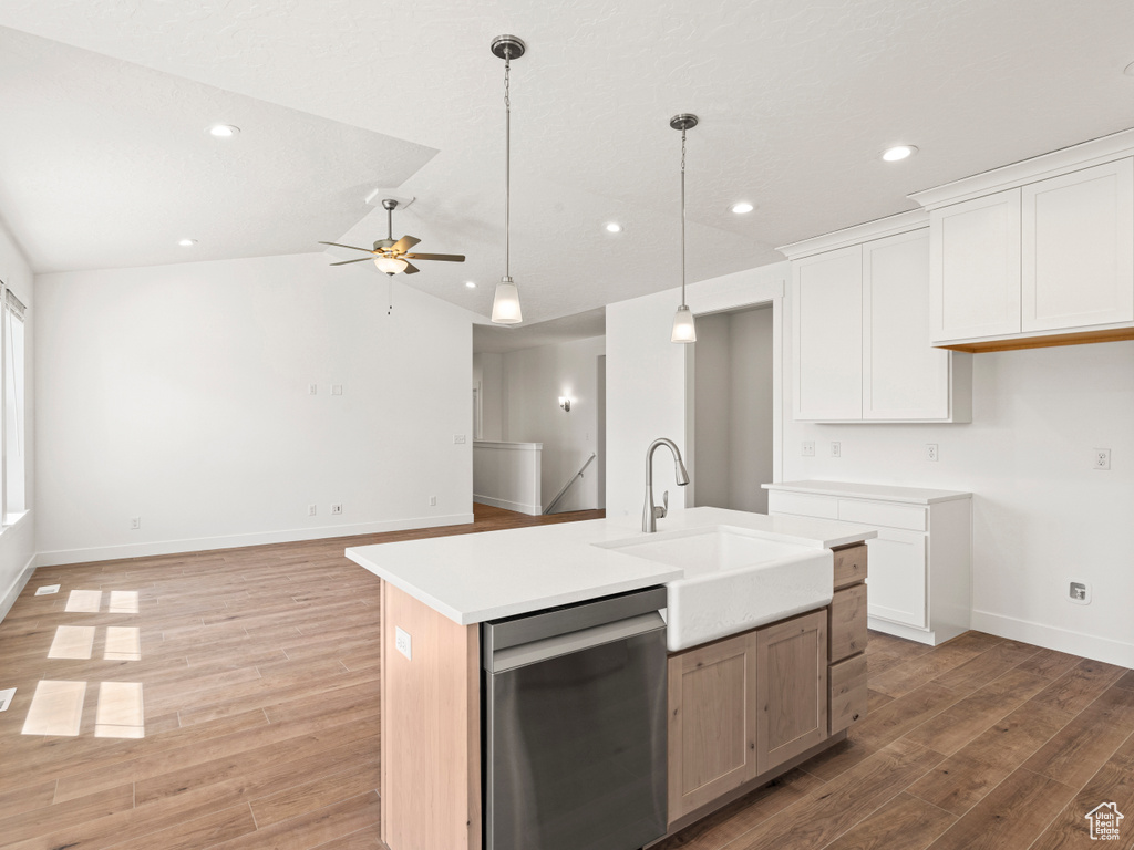 Kitchen with dishwasher, ceiling fan, white cabinetry, and a kitchen island with sink