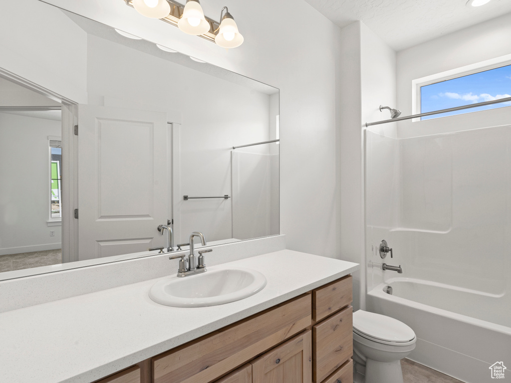 Full bathroom with vanity, toilet, and tub / shower combination