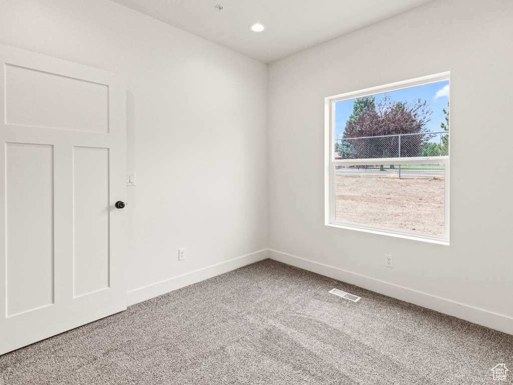 Spare room featuring light carpet