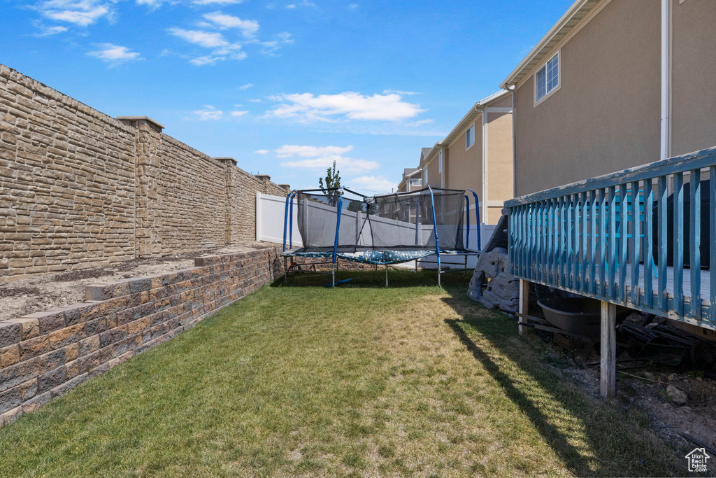 View of yard featuring a trampoline