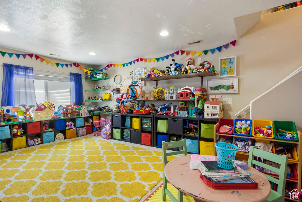 Rec room featuring a textured ceiling