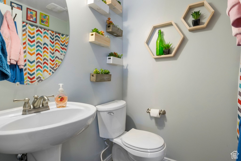 Bathroom featuring sink and toilet