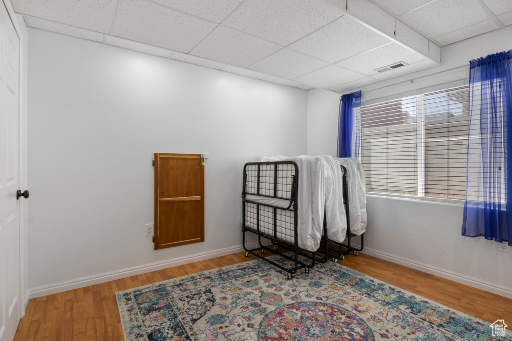 Misc room with a drop ceiling and light wood-type flooring