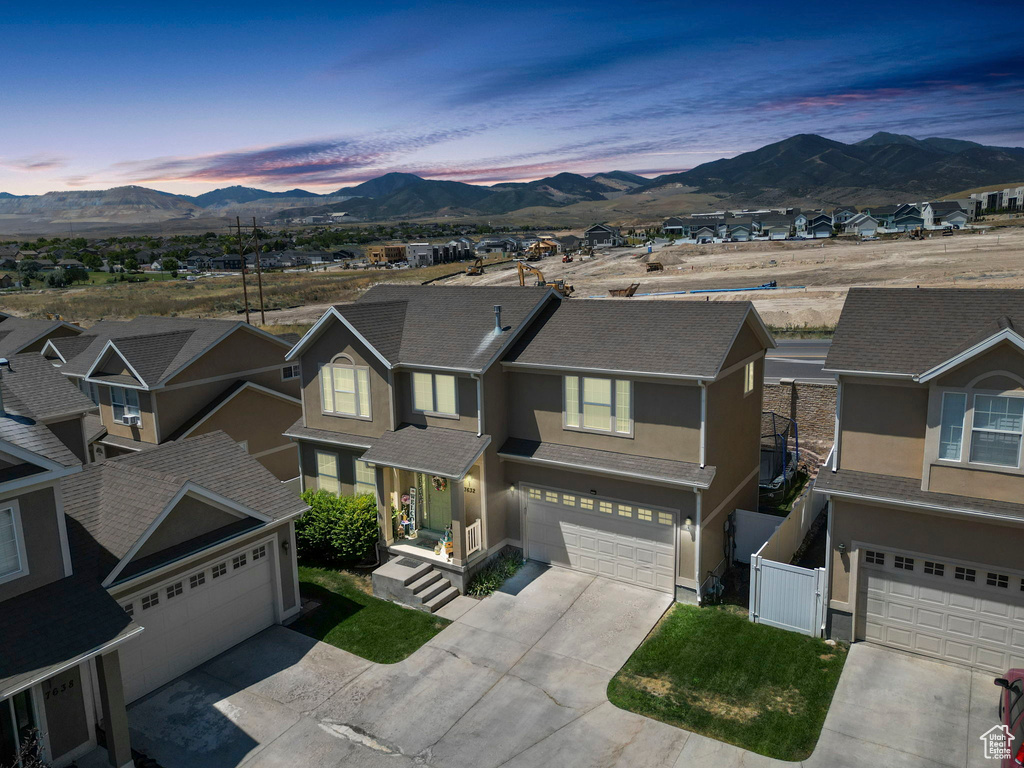 View of front of house featuring a garage and a mountain view