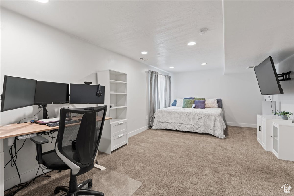 Bedroom with light colored carpet