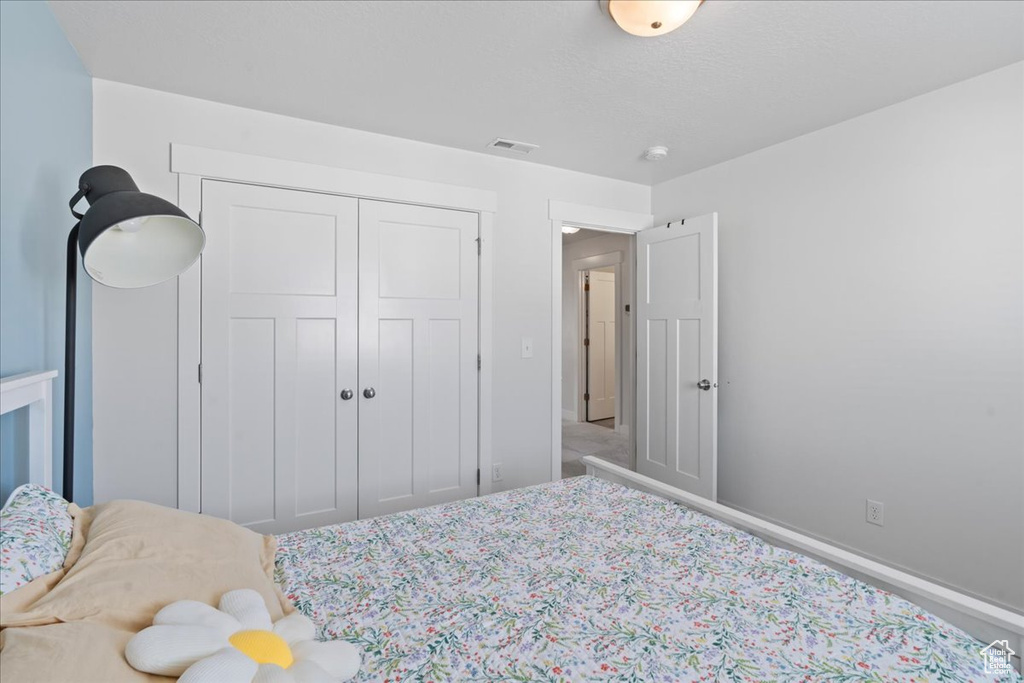 Bedroom with a closet and carpet