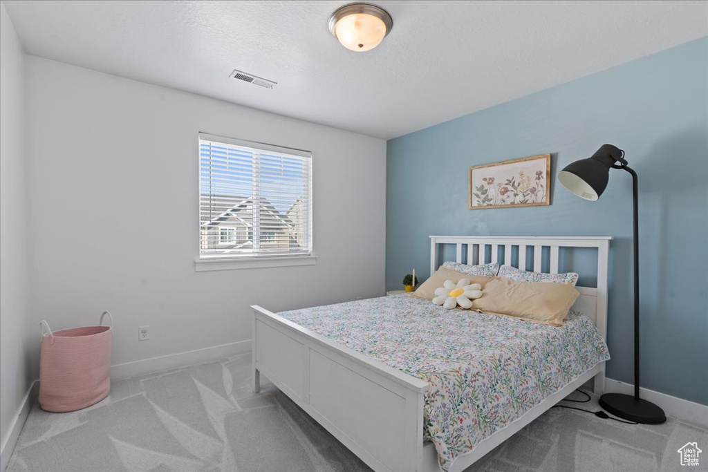 Bedroom with light carpet