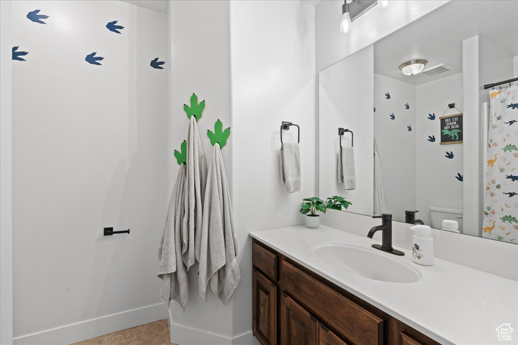 Bathroom featuring vanity and toilet