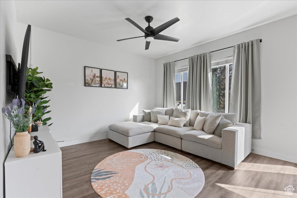 Living room featuring wood-type flooring and ceiling fan