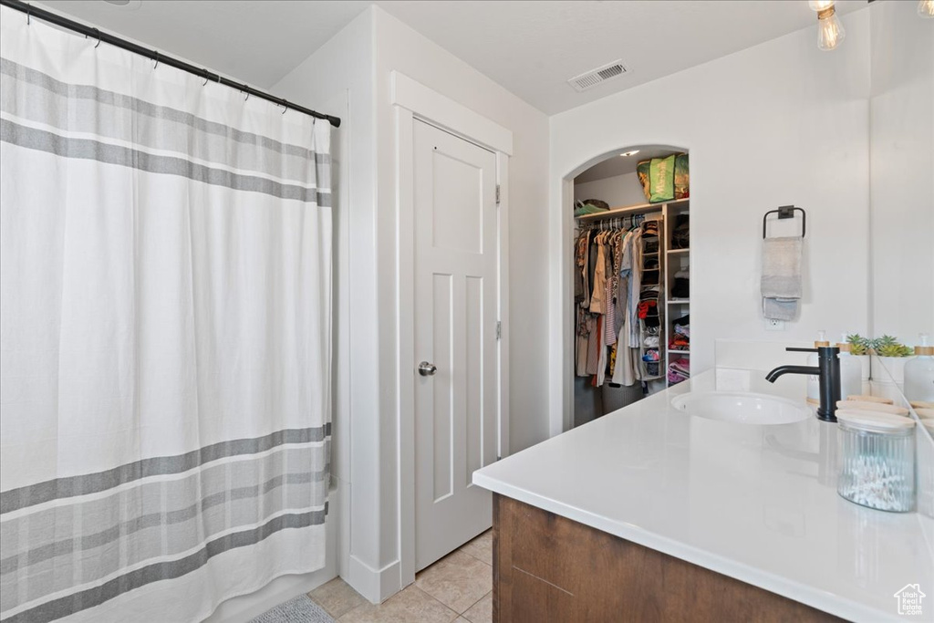 Bathroom featuring vanity and tile patterned floors