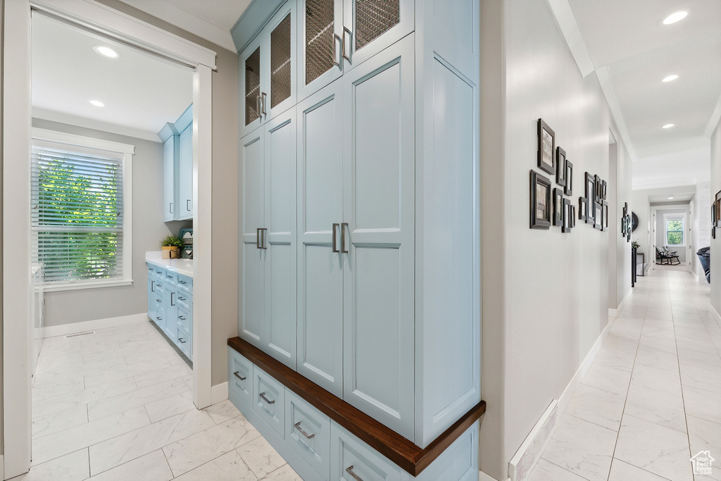 Interior space with ornamental molding and light tile patterned floors