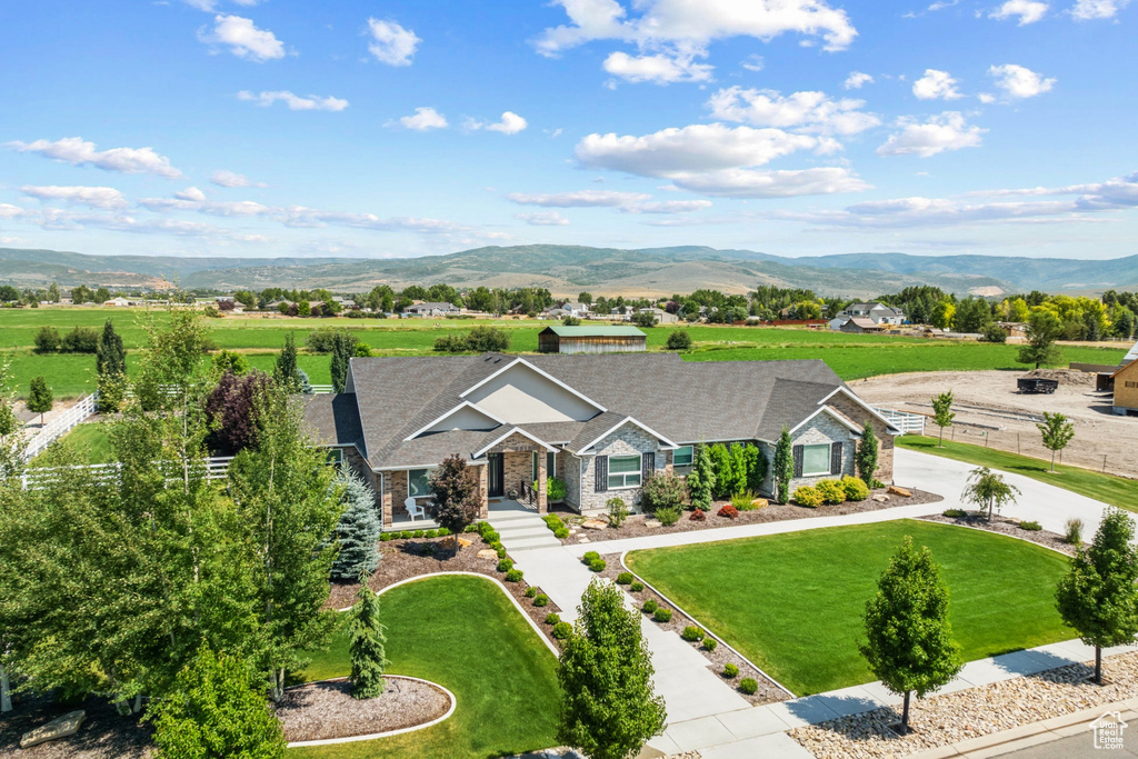 Ranch-style house with a mountain view and a front yard