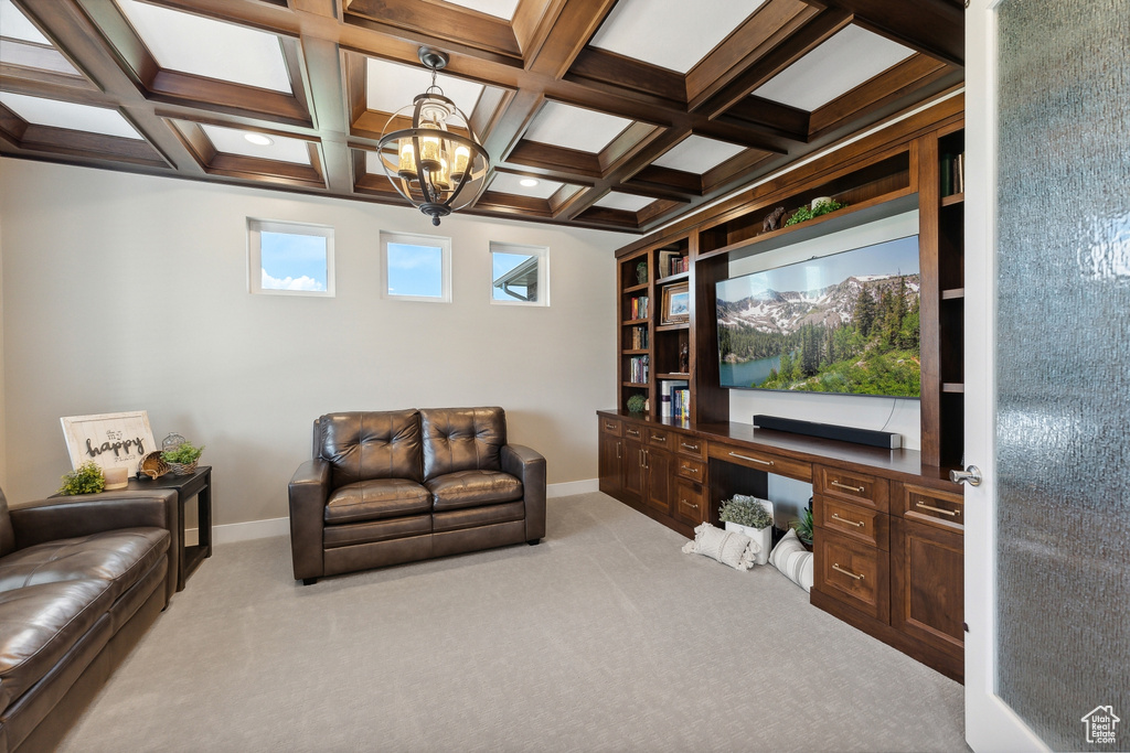 Office space featuring an inviting chandelier, light colored carpet, and coffered ceiling