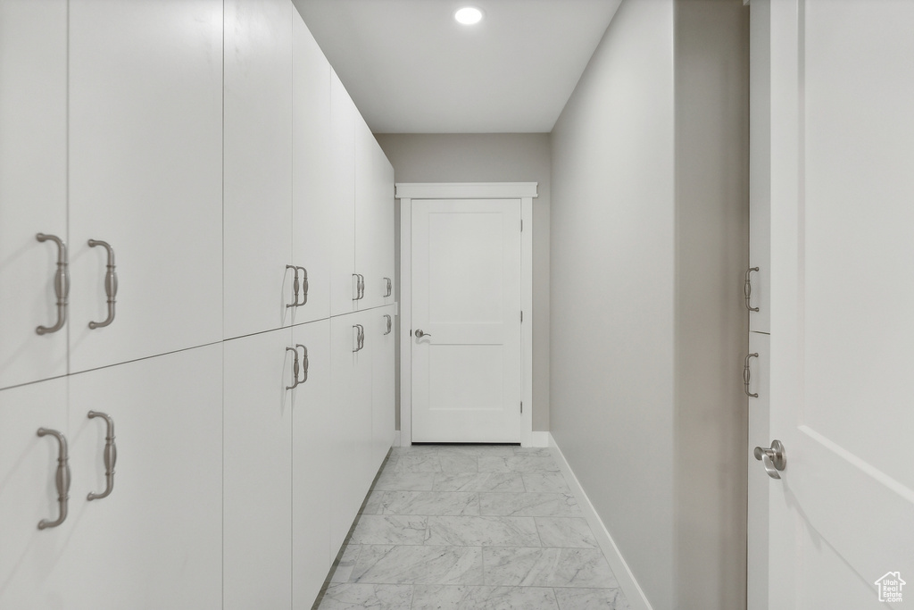 Hallway featuring light tile patterned floors