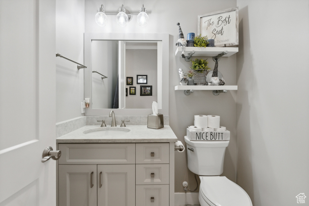 Bathroom featuring vanity and toilet