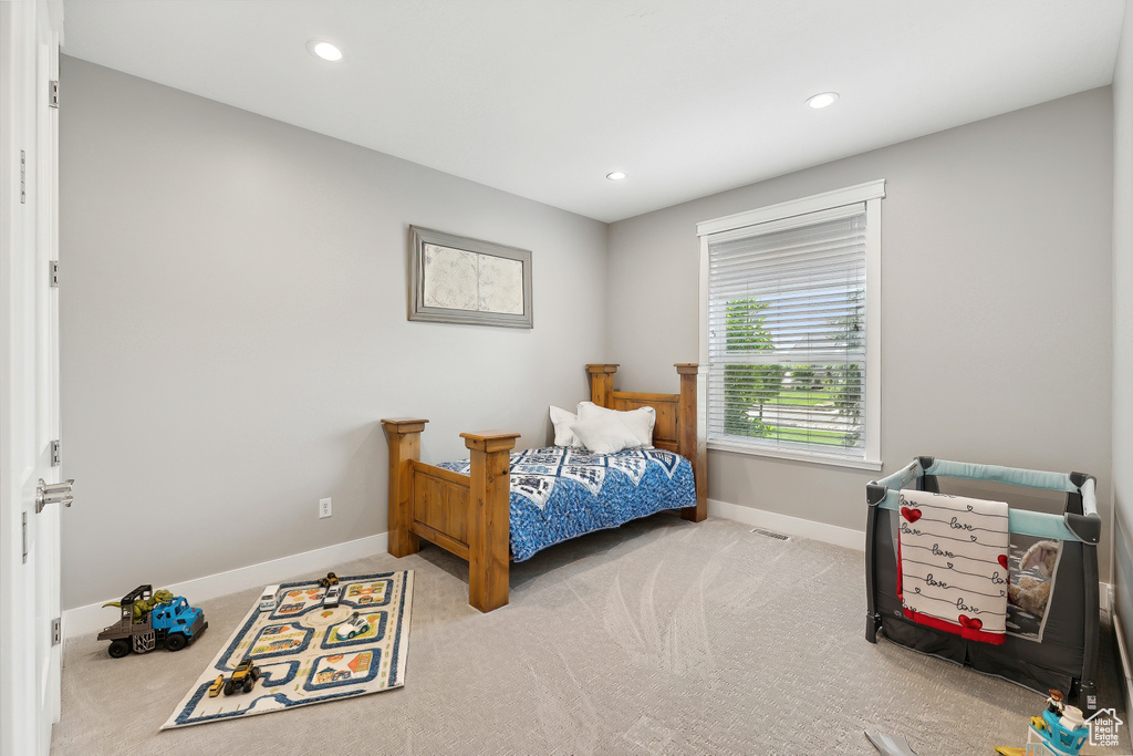 Bedroom with light colored carpet