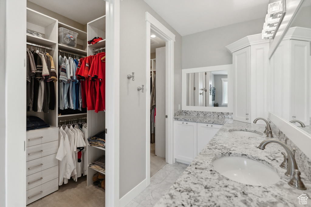 Bathroom with double vanity and tile patterned flooring