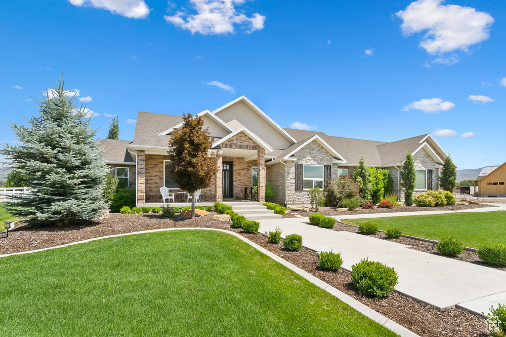 Craftsman-style home featuring a front lawn